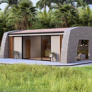 May include: A modern, stone-clad house with a curved roof and large glass sliding doors. The home is surrounded by lush greenery, including palm trees and grass. The interior is visible through the glass, showcasing a minimalist design.