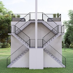 May include: A symmetrical architectural structure with two sets of stairs, each ascending from opposite sides. The stairs are concrete with black metal railings. The structure is set in a grassy area with trees in the background.