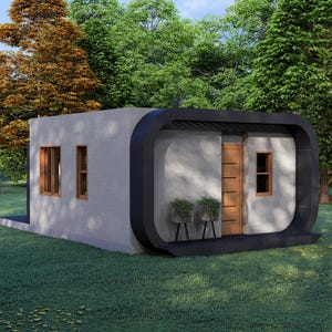 May include: A modern, minimalist house with a flat roof and rounded black trim. The exterior is light gray with wooden doors and windows. The house is surrounded by green grass and trees.