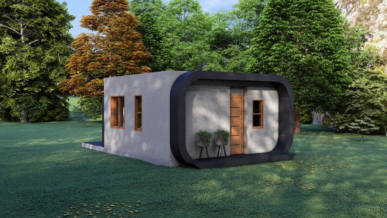 May include: A modern, minimalist house with a flat roof and rounded black trim. The exterior is light gray with wooden doors and windows. The house is surrounded by green grass and trees.