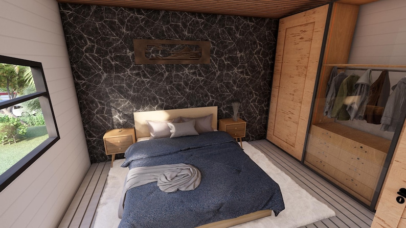 K&ouml;nnte beinhalten: Schlafzimmer-Interieur mit Bett, Nachttischen und einem gro&szlig;en Holzschrank. Das Bett hat eine blaue Bettdecke und Kissen. Die W&auml;nde sind wei&szlig; und schwarz mit einem gro&szlig;en Fenster. Der Raum hat ein modernes Design.