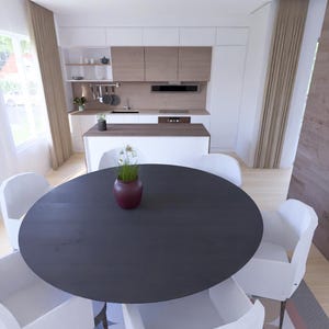 Puede incluir: Una cocina y comedor modernos con una mesa redonda oscura rodeada de sillas blancas. Un jarr&oacute;n con flores est&aacute; sobre la mesa. La cocina cuenta con gabinetes blancos y detalles de madera.