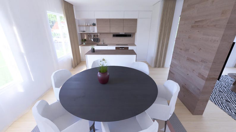 Puede incluir: Una cocina y comedor modernos con una mesa redonda oscura rodeada de sillas blancas. Un jarr&oacute;n con flores est&aacute; sobre la mesa. La cocina cuenta con gabinetes blancos y detalles de madera.