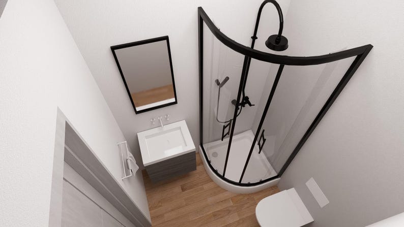 以下が含まれることがあります： 黒いフレームのシャワー、白い洗面台、トイレを備えたモダンなバスルームの俯瞰図。 シャワーは湾曲したガラスドアと黒い備品を備えています。 壁は白く、床は木目調です。