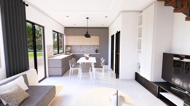 May include: Interior view of a modern living space with a kitchen and dining area. The kitchen features gray cabinets and a light wood backsplash. A white dining table with gray chairs is set in front of the kitchen. The living area has a gray sofa and a round coffee table.