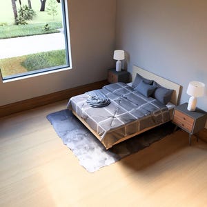 May include: Bedroom interior with a bed, nightstands, and a large window. The bed has a gray and white patterned comforter and pillows. Two nightstands with lamps flank the bed. A rug sits beneath the bed.
