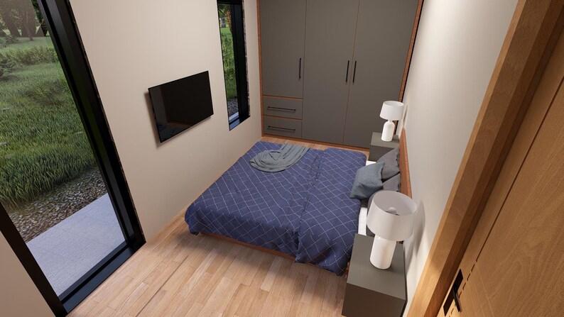 May include: Bedroom interior with a blue patterned bedspread, gray pillows, and a gray blanket. The room has a large window, a wall-mounted TV, and two bedside lamps. A large closet is visible.