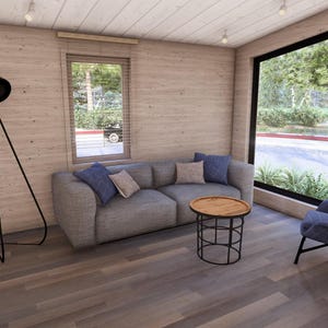 Puede incluir: Un sal&oacute;n moderno con un sof&aacute; gris, cojines azules y beige, y una mesa de centro redonda de madera. Una l&aacute;mpara de pie negra y un sill&oacute;n azul tambi&eacute;n est&aacute;n presentes. Grandes ventanales ofrecen vistas al exterior.