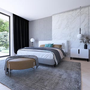 May include: A contemporary bedroom scene with a large window offering a view of greenery. The room includes a bed with a white headboard, a grey rug, a brown ottoman, and a white cabinet. Black curtains are present.