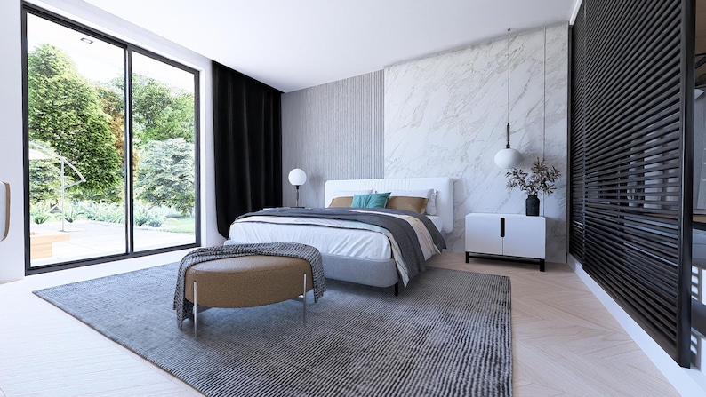 May include: A contemporary bedroom scene with a large window offering a view of greenery. The room includes a bed with a white headboard, a grey rug, a brown ottoman, and a white cabinet. Black curtains are present.