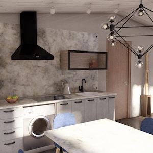 Puede incluir: Una cocina moderna con gabinetes gris claro, un refrigerador negro y una campana extractora negra. Una lavadora est&aacute; integrada en los gabinetes. Una l&aacute;mpara de ara&ntilde;a geom&eacute;trica cuelga sobre una mesa blanca y sillas azules.