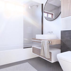 Puede incluir: Interior de ba&ntilde;o moderno con ba&ntilde;era, lavabo e inodoro blancos. La habitaci&oacute;n cuenta con un espejo grande, gabinetes de madera y una pared de acento de azulejos grises. Una toalla cuelga del lavabo. El suelo tiene un patr&oacute;n de espiga gris.