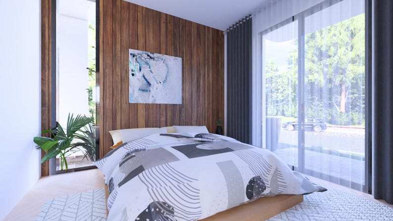 Puede incluir: Un dormitorio moderno con una cama grande con un edred&oacute;n estampado en tonos grises y blancos. La habitaci&oacute;n tiene una pared de acento de madera con una pintura abstracta, ventanas grandes y cortinas transparentes. Una planta a&ntilde;ade un toque de vegetaci&oacute;n.