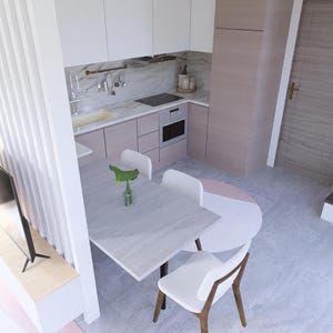Op de afbeelding: Een moderne keuken en eethoek met een licht kleurenschema. De keuken heeft witte kasten, een marmeren achterwand en roestvrijstalen apparatuur. Een kleine tafel met witte stoelen is ingericht om te dineren. Een trap leidt naar de bovenverdieping.
