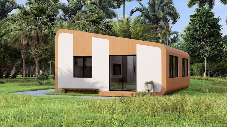 Puede incluir: Una caba&ntilde;a moderna y minimalista con exterior de madera clara y detalles blancos. La estructura presenta grandes ventanas, una puerta corredera de cristal y un peque&ntilde;o banco. La caba&ntilde;a est&aacute; situada en una zona verde.