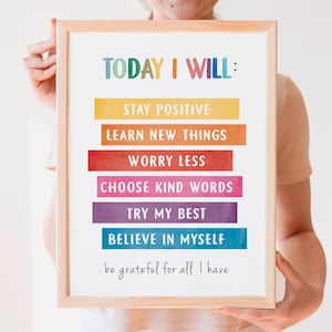 May include: A framed motivational poster with the text "TODAY I WILL:" and a list of positive affirmations in colorful watercolor stripes. The affirmations include "Stay Positive", "Learn New Things", "Worry Less", "Choose Kind Words", "Try My Best", "Believe In Myself", and "Be grateful for all I have."