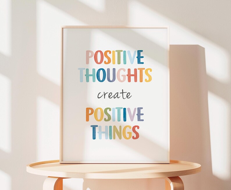 May include: A framed print with the text "POSITIVE THOUGHTS create POSITIVE THINGS" in colorful letters on a white background.
