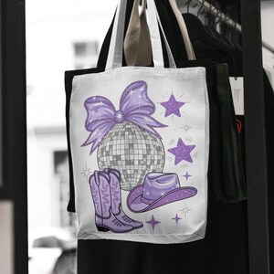 May include: A white tote bag with a purple disco ball, a purple bow, purple cowboy boots, and a purple cowboy hat with stars.