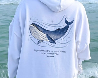 Peut inclure: Sweat-shirt à capuche blanc avec un graphique de baleine bleue et le texte "Mightier than the waves of the sea is his love for you. PSALM 93:4" au dos.