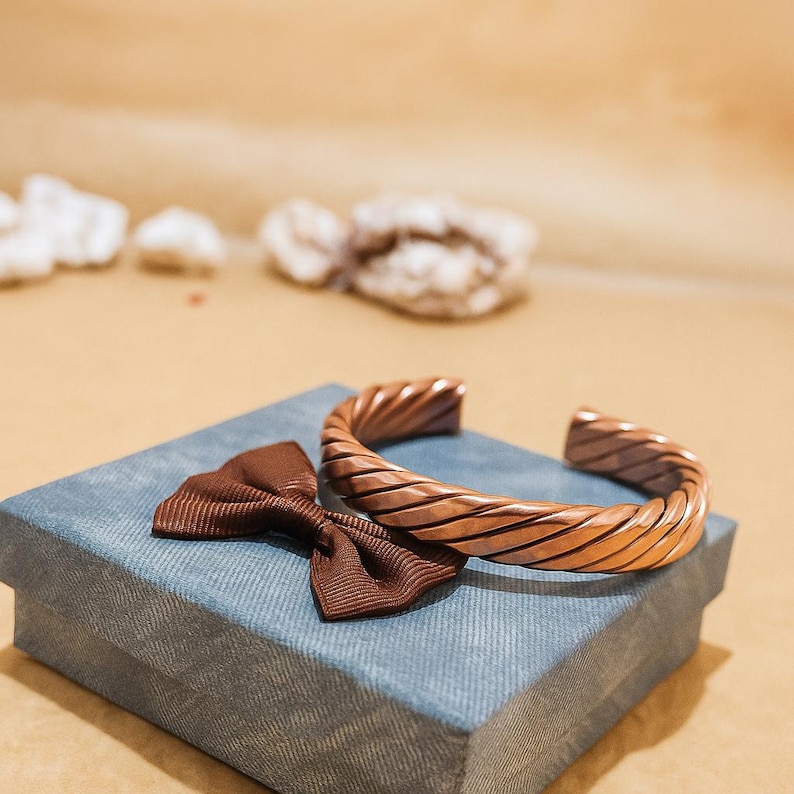 Copper bracelet shown on a small packaging box