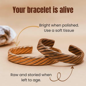 A studio shot of two versions of the same bracelet, arranged so they rest laid flat and leaning gently against each other. One bracelet is placed slightly in front at a low angle, while the other rests just behind it. One bracelet is freshly polished, bright, and lustrous with a clean copper shine. The other shows a natural aged look, with a mild dark patina. Instructions read: " Raw and storied when left to age" for Patina bracelet and " Bright when polished" for the polished bracelet.