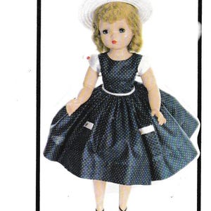 May include: A vintage doll wearing a navy blue dress with white polka dots, a white hat, and black sandals. The doll has blonde hair and is posed in a standing position. The dress has a white belt and white accents.