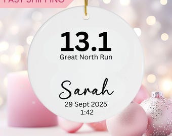 May include: White ceramic ornament with black text that reads "13.1 Great North Run Sarah 29 Sept 2025 1:42".