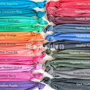 May include: A collection of fabric swatches in various heather colors, including sapphire, Galapagos blue, seafoam, Irish green, orange, bronze, coral silk, heliconia, radiant orchid, berry, purple, red, cardinal, maroon, indigo, royal, navy, military green, forest green, graphite heather, and dark heather. The swatches are arranged in two rows, with the text "THE WITTY WILLOW CO" printed in the center.