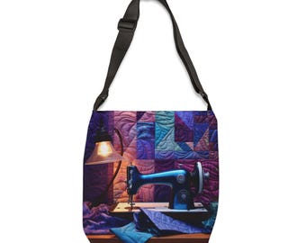 Pode incluir: Bolsa de ombro com uma ilustração vibrante de uma máquina de costura, uma lâmpada e tecido contra um fundo acolchoado. A bolsa tem uma alça preta e apresenta um design artístico detalhado com tons de azul, roxo e verde-azulado.
