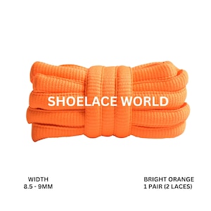 May include: Bright orange shoelaces, 8.5-9mm wide, with the text "SHOELACE WORLD". The image shows a pair of bright orange shoelaces, tightly coiled. The shoelaces are a vibrant orange color, and the text is in white.