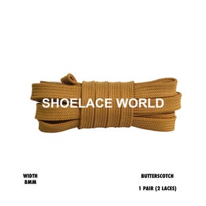 May include: Butterscotch-colored shoelaces, 8mm wide, are bundled together. The text "SHOELACE WORLD" is printed across the laces. The product is labeled as "1 Pair (2 Laces)."