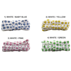 May include: Four sets of shoelaces with smiley face patterns. The sets are white with baby blue, yellow, pink, and green smiley faces. The text "SHOELACE WORLD" is printed on each set.