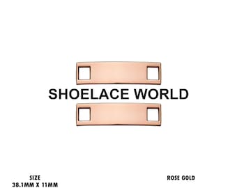 May include: A pair of rose gold metal shoelace tags, each featuring a rectangular plate with a square hole on both ends. The tags measure 38.1mm by 11mm with a 5mm hole for lace insertion. The text SHOELACE WORLD is centred between the two tags.