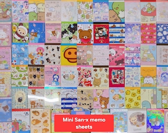 May include: A collection of colorful Mini San-x memo sheets, each featuring different cartoon characters and designs. The sheets are rectangular and vary in size, with a variety of pastel colors and illustrations. The text "Mini San-x memo sheets" is visible at the bottom.