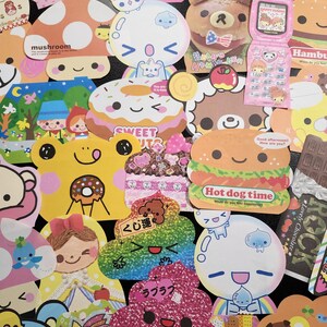 May include: A collection of colorful, cartoon-themed stickers featuring various characters, food, and objects. The stickers are decorated with glitter, hearts, and other embellishments. Some of the stickers have Japanese text, including "mushroom", "sweet", "hot dog time", "くじ運" (lucky charm), and "ラブラブ" (love love).