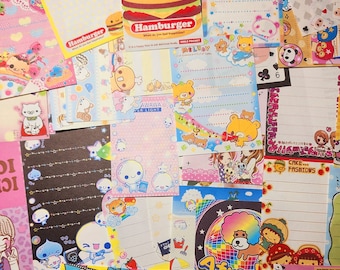 May include: A collection of colorful, patterned paper notes featuring various cartoon characters, including pandas, bears, and a hamburger. The notes are decorated with stars, hearts, and other whimsical designs. The text on the notes includes "Smile Pocket", "Hamburger", "Awaawa Per Light", "Melody", "Minty Pan-ha", "Baby Infinite", "Cake... Fashions", and "Miracle Girls".