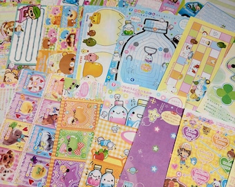 Pode incluir: Uma coleção de adesivos coloridos de personagens de desenhos animados japoneses com uma variedade de personagens, incluindo animais, pessoas e comida. Os adesivos são impressos em papel branco e têm um acabamento brilhante.