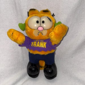 May include: A set of three ceramic mugs with a speckled, matte finish. The mugs are in shades of cream, light gray, and dark gray. Each mug has a simple, minimalist design, perfect for coffee or tea.