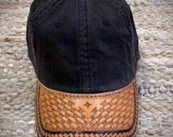 Ball cap with a leather Brim which is hand carved and tooled by Sharon Trandem