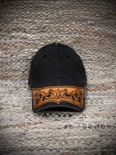 Ball cap with a leather Brim which is hand carved and tooled by Sharon Trandem