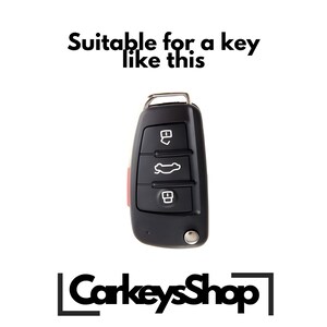 May include: Black car key with three buttons and a red accent. The key has a metal loop for attaching to a keyring. The text "Suitable for a key like this" is above the key.