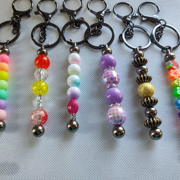 Stunning Beaded keychains on a black post. Be the first among your friends to have this one-of-a-kind beaded keychain Great graduation gift.