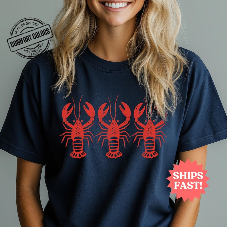 Comfort Colors T-shirt in navy featuring a bold red lobster graphic repeated across the chest, perfect for fisherman aesthetic and beach vibes.
