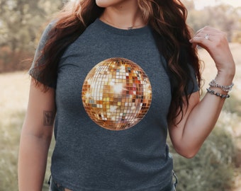 May include: A dark gray t-shirt with a gold disco ball graphic.