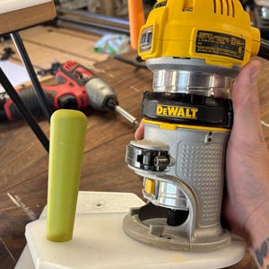 May include: A yellow and silver DeWalt DWP611 compact router with a green handle. The router is mounted on a white base. Text on the image reads "FOR REFERENCE ONLY - LISTING WILL REFLECT CORRECT BRAND OF ROUTER." and "READ MORE IN THE DESCRIPTION."