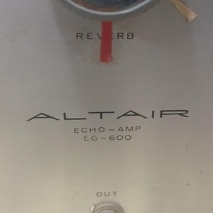 May include: A silver-colored audio amplifier with the text "ALTAIR ECHO-AMP LG-600" and knobs for adjusting level and reverb.