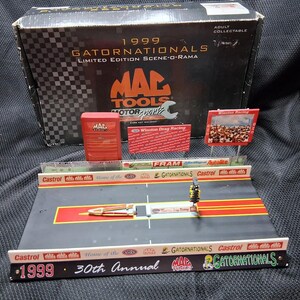 May include: A 1999 Gatornationals Limited Edition Scene-O-Rama model kit. The kit includes a drag racing track, signage, and a box with the Mac Tools logo. The kit is a collectible item.