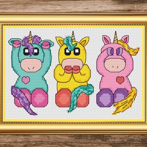 May include: Three cartoon unicorns, each with a different colored body and horn, are shown covering their eyes, ears, and mouth with their hands. The unicorn on the left is teal, the middle unicorn is yellow, and the unicorn on the right is pink.