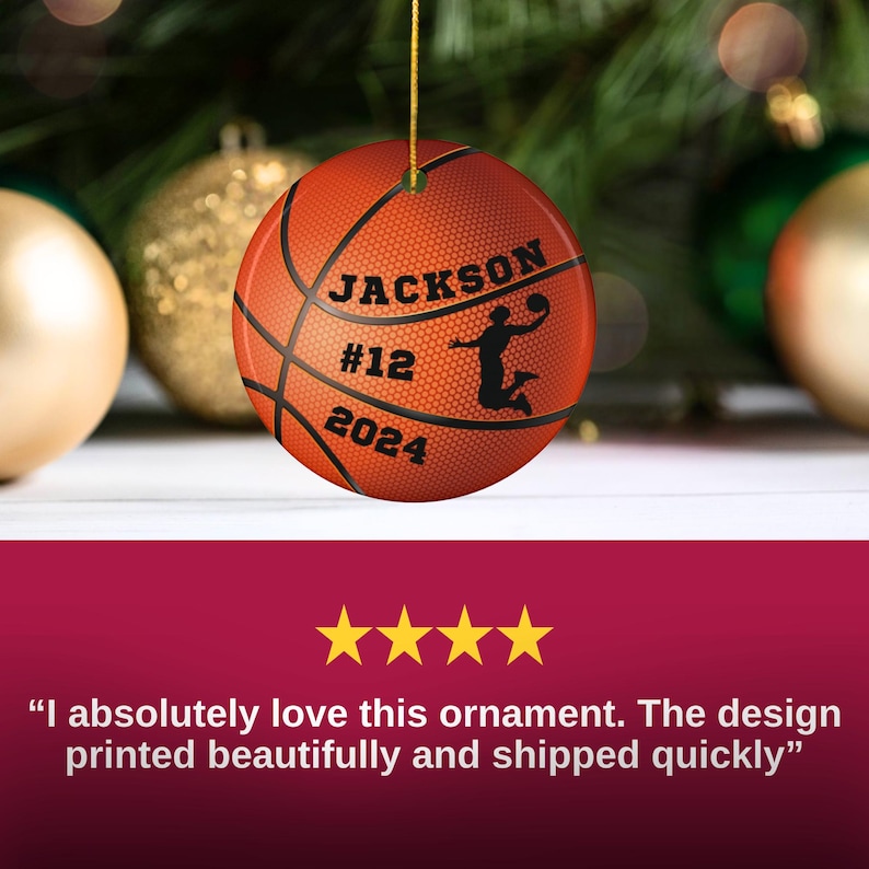 May include: A basketball-themed Christmas ornament. The orange ornament features black lines mimicking a basketball, with the name "JACKSON", the number "12", and the year "2024". A silhouette of a basketball player is also visible.
