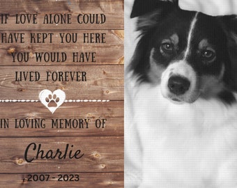 May include: A wooden memorial plaque with a black and white photo of a dog. The plaque has the text "If love alone could have kept you here you would have lived forever" and "In loving memory of Charlie 2007-2023".